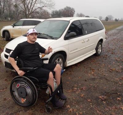 Michael Akins by his refurbished accessible minivan
